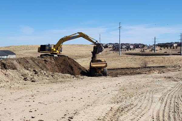 Excavator digging on an open Front Range site