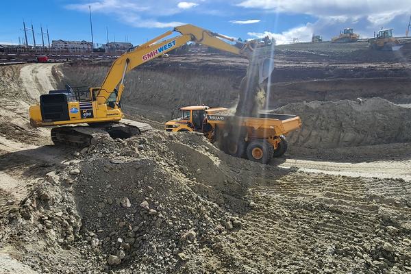 Excavator loading an articulated haul truck