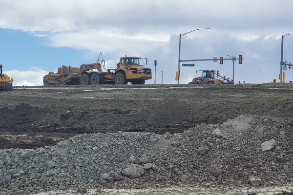 Dozers working a large site next to a highway